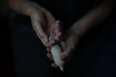 Noelle's mother is holding a rock crystal that a friend gave to her, Noelle carved the cover when she was still alive. She always brought both to all court sessions.
