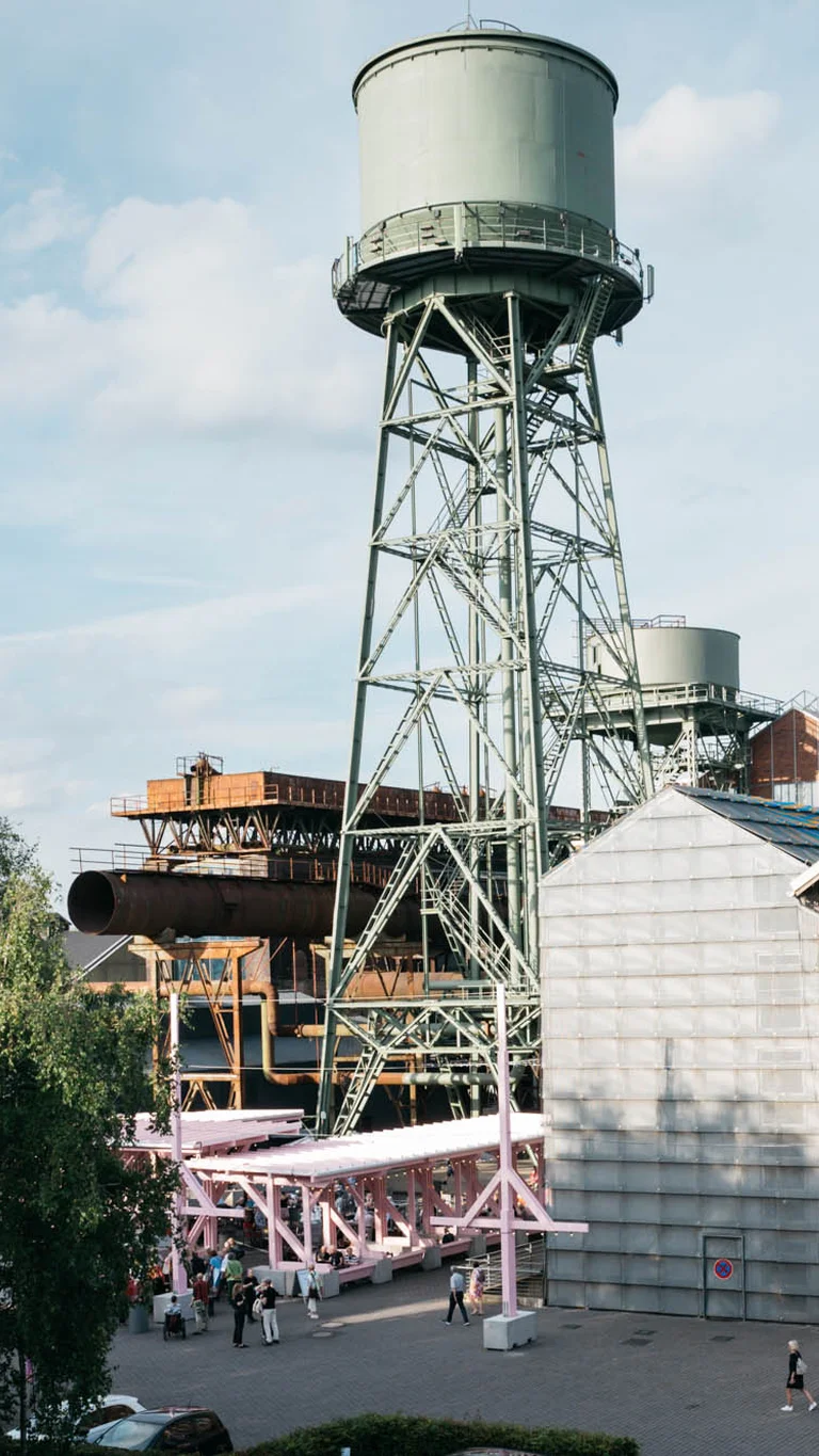 Ein alter Wasserturm ragt über das Festivalzentrum Wunderland, umgeben vom Bochumer Jahrhunderthallekomplex.