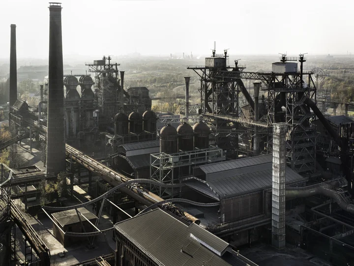 Industrial landscape of the Landschaftspark Duisburg-Nord with impressive blast furnaces and pipe systems, captured from a bird's-eye view.