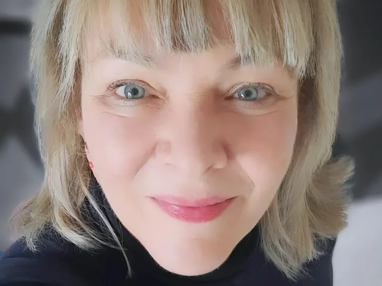 A person smiles into the camera.