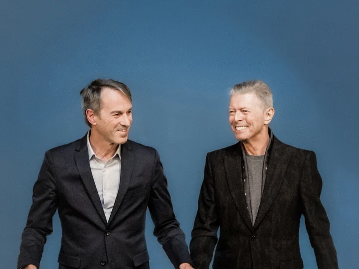 Ivo Van Hove with David Bowie against a blue background
