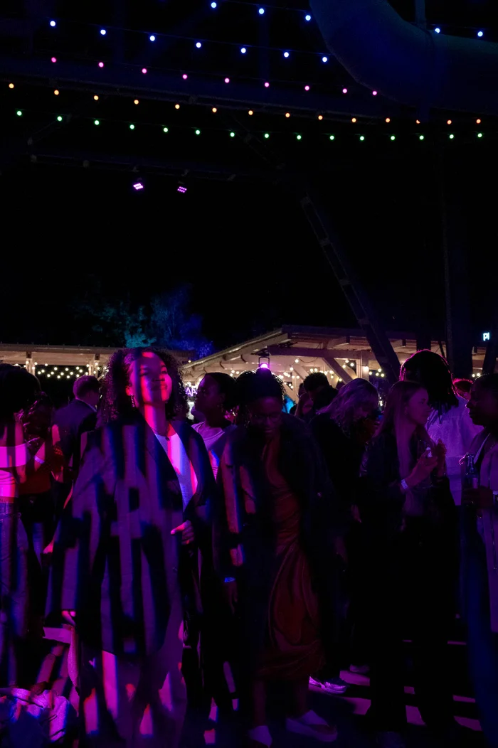 Visitors dance at a night-time party in the colourful lights of the Ruhrtriennale festival centre.