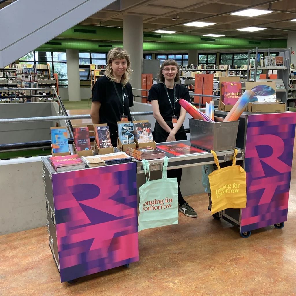 Two Ruhrtriennale employees at the marketing stand set up in Bochum City Library.