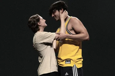 Diego Rodriguez and Ari Notartomaso, holding each other and looking at one another.