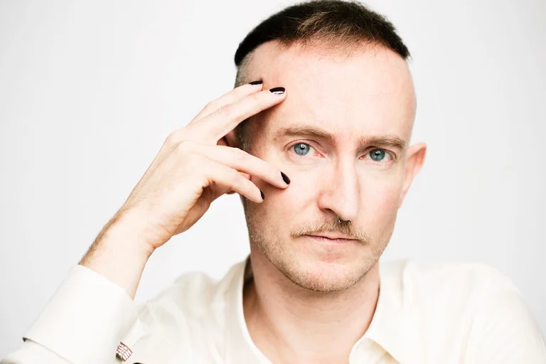 Man in a white shirt looking into the camera