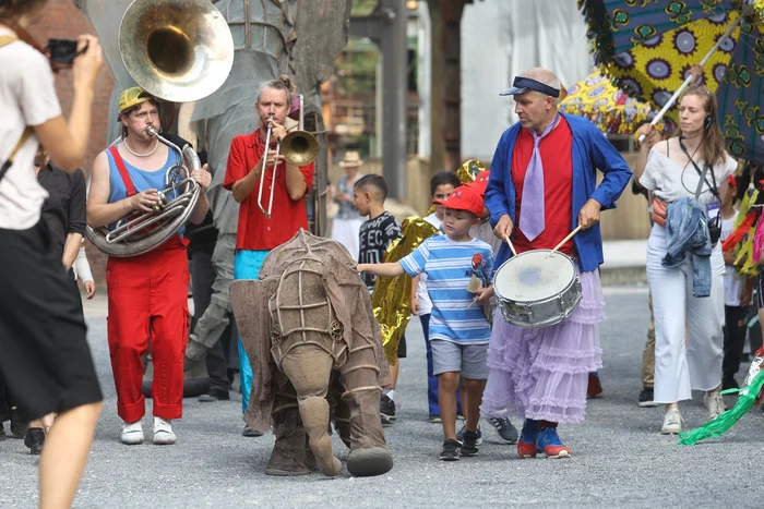 The ‘Celebration Parade’ with the figure of a baby elephant, surrounded by musicians as well as children and adults.