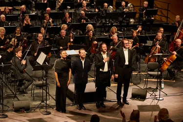 Axelle Saint-Cirel, Enguerrand de Hys, Jérôme Boutillier und Christian Schmitt stehen nach einem Konzert vor den applaudierenden Bochumer Symphonikern auf der Bühne.