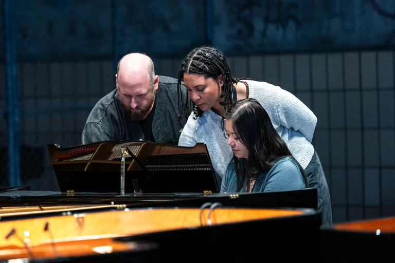 The musicians of Wild Up at the piano
